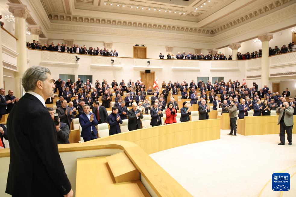 12月14日，在格魯吉亞首都第比利斯，人們?cè)谶x舉結(jié)果公布后起立向卡韋拉什維利表示祝賀。新華社發(fā)（格魯吉亞議會(huì)辦公廳供圖）