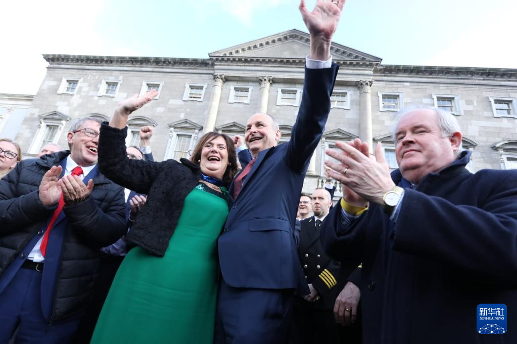 1月23日，在愛爾蘭都柏林，米歇爾·馬?。ㄖ校┡c妻子在議會外向人群揮手致意。新華社發(fā)（愛爾蘭議會供圖）