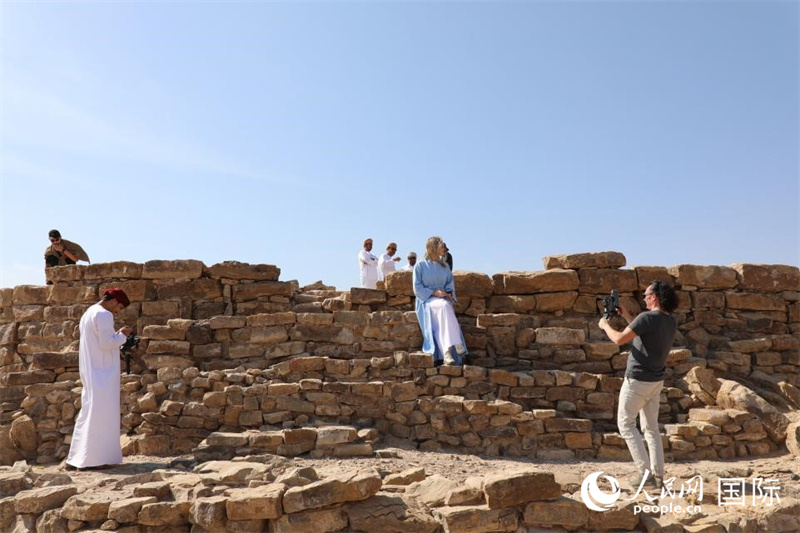 游客在巴特考古遺址中的一處塔樓遺址前拍照留影。人民網(wǎng)記者 沈小曉攝