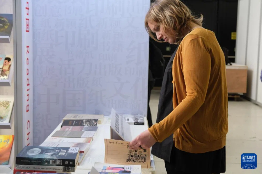 5月15日，在捷克首都布拉格，參觀者在布拉格國(guó)際書展的中國(guó)展區(qū)翻閱圖書。新華社記者 鄧耀敏 攝