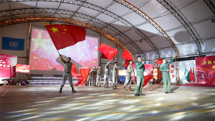 中國維和官兵表演歌伴舞《紅旗飄飄》。秦英章 攝