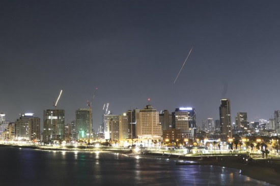 6月19日凌晨，在以色列特拉維夫，防空系統(tǒng)發(fā)射攔截彈留下光亮的軌跡（畫面右側(cè)）。 新華社發(fā)（賈馬爾·阿瓦德攝）
