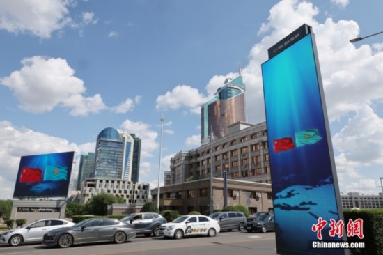 當(dāng)?shù)貢r間6月15日，哈薩克斯坦首都阿斯塔納街頭，中哈兩國國旗飄揚。中新社記者 盛佳鵬 攝