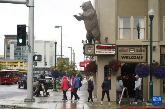 　　8月14日，行人從美國阿拉斯加州安克雷奇市中心街頭走過。新華社記者吳曉凌攝