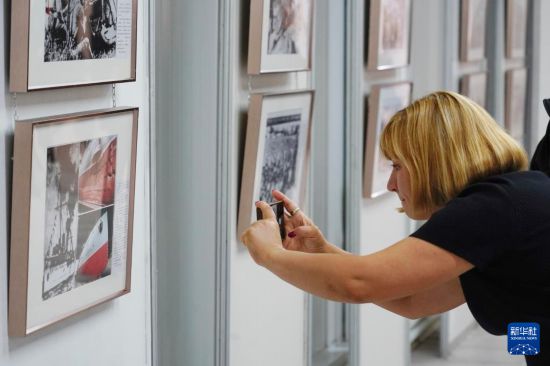 8月28日，在俄羅斯圣彼得堡，一名女子參觀紀(jì)念中國(guó)人民抗日戰(zhàn)爭(zhēng)暨世界反法西斯戰(zhàn)爭(zhēng)勝利80周年圖片展。新華社記者 周天翮 攝