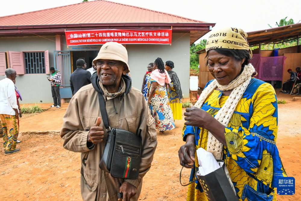 7月24日，在喀麥隆首都雅溫得郊外的阿法諾亞村，約瑟菲娜（右）和丈夫來(lái)到中國(guó)援喀麥隆醫(yī)療隊(duì)義診現(xiàn)場(chǎng)問(wèn)診。新華社發(fā)（科普索攝）